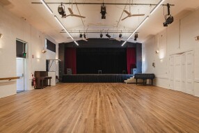 Wooden floor hall with stage in background