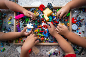 Childrens hands in box of lego